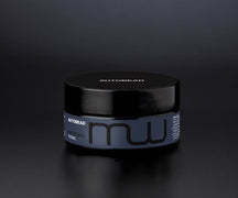 Autobead Matte Wax 100ml tub with a black lid and slate blue label on a dark studio background