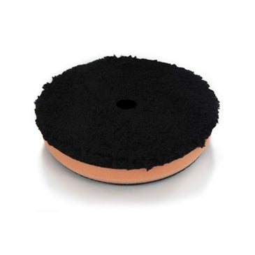 Chemical Guys 5.5in Cutting Pad with fluffy black face on an orange foam base
